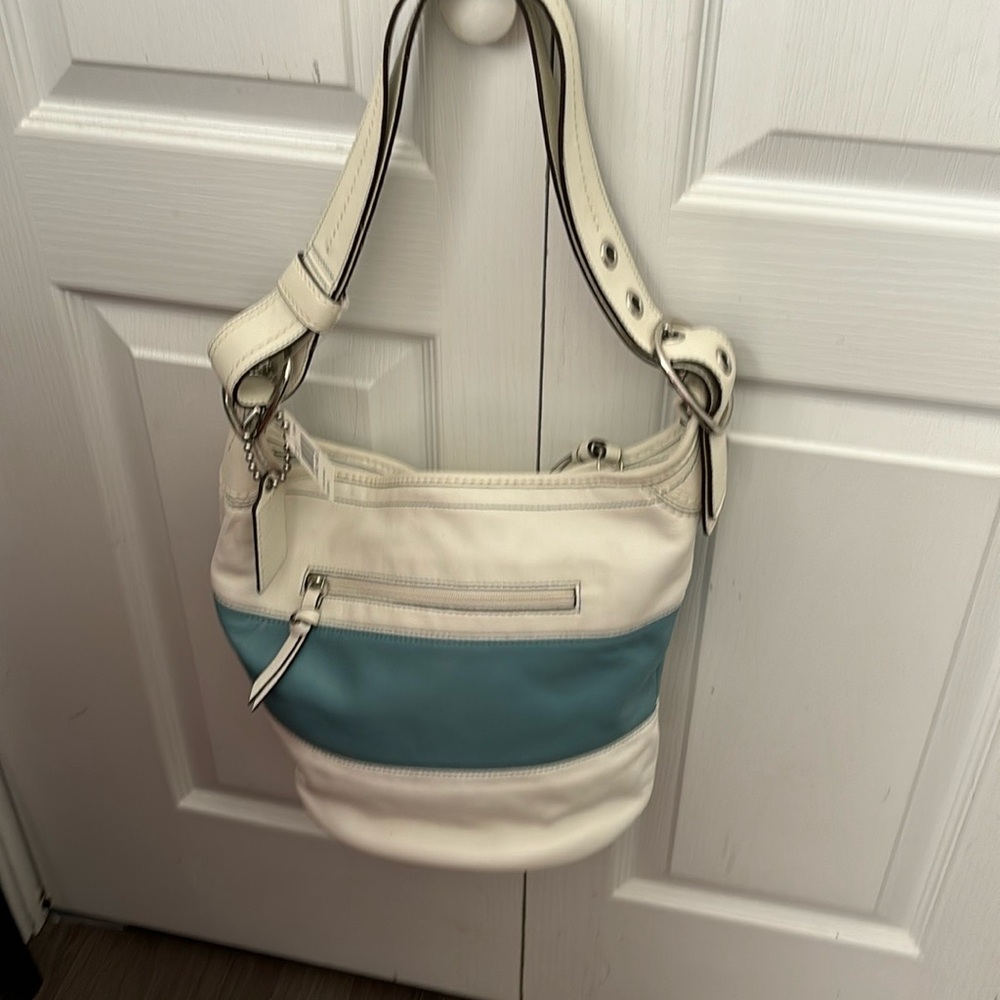 Coach medium hobo bag, blue and off white. Inside pockets and storage area.